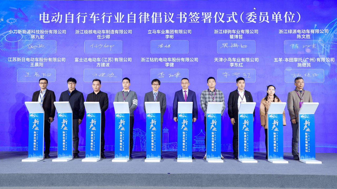 Group of people at a formal event in Cambodia, showcasing a store display related to WooCommerce apps, with a blue backdrop and podiums, emphasizing e-commerce solutions.