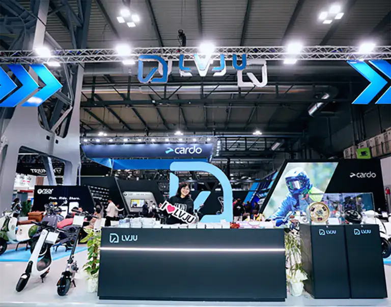 Brightly lit EV exhibition with electric scooters and bikes on display, showcasing the latest in electric vehicle technology and eco-friendly transportation solutions at a trade show.